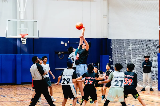 Players on an indoor Fitcourts basketball court